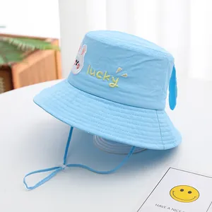 Detail of light blue baby sun hat with cute rabbit embroidery and adjustable chin strap