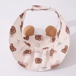 Close-up of pink baby sun visor with cute bear ears and adjustable Velcro strap back