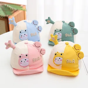 Detail of baby soft brim baseball caps with 3D ears in pink, yellow, blue and green