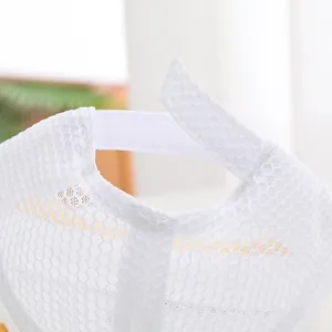 Detail of white mesh sun hat featuring breathable honeycomb fabric and velcro strap