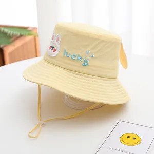 Detail of yellow toddler bucket hat featuring rabbit embroidery and 3D bunny ears