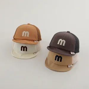 Detailed view of breathable mesh baby baseball caps with soft brim and M letter embroidery
