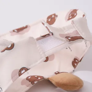 Detail of infant sun hat with bear prints, elastic band, and plush ear decorations