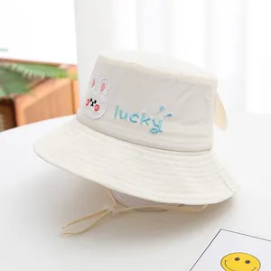 Detail of baby sun hat featuring cute rabbit embroidery and adjustable windproof strap