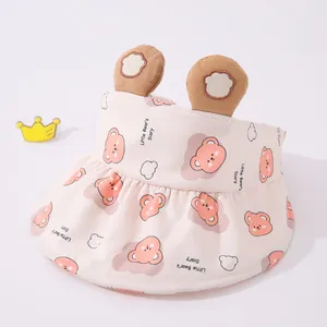 Detail of pink toddler sun hat with bear pattern and 3D ears on a soft grey background