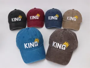 Detail of KING embroidery and crown on washed cotton baseball caps for kids