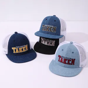 Detail of denim mesh truck caps with TAKEN 3D embroidery in four classic colors