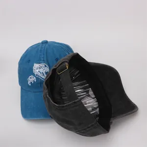 Vue détaillée des casquettes de baseball en coton avec broderie dinosaure et boucle métal