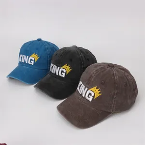 Detailed view of kids' baseball caps with KING embroidery in blue, black, and brown cotton