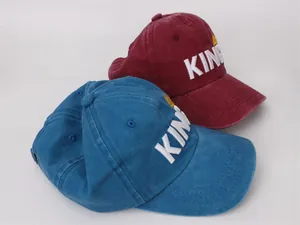 Detailed close-up of blue and red vintage baseball caps with KING crown 3D embroidery
