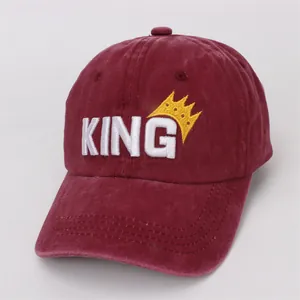 Close-up of burgundy washed cotton baseball cap with 3D KING embroidery and crown