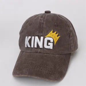 Detail of KING embroidery and crown on washed cotton baseball cap with stitch texture