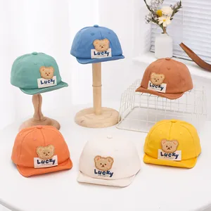 Detail of soft cotton baby baseball caps with cute bear embroidery in various colors
