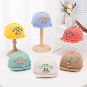 Detail of baby baseball caps in pastel colors with cartoon cat and letter embroidery