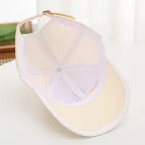 Internal view of beige kids baseball cap with reinforced seams and adjustable strap