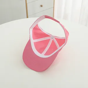 Detail of pink visor cap showing fine stitching on the brim and internal piping