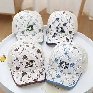 Detail of four breathable mesh baby baseball caps with bear prints and letter labels