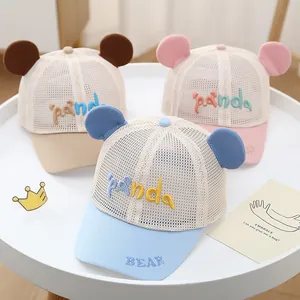 Close-up of three mesh baby baseball caps in blue, pink, and khaki with cute panda ears