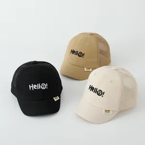 Detail of mesh trucker hats for kids with Hello embroidery and breathable back panels