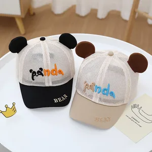 Close-up of mesh baseball caps with cute bear ears and panda embroidery for kids