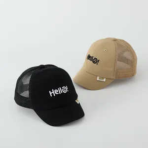 Detail of mesh breathable kids baseball cap with Hello embroidery and smiling face design