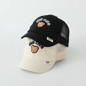 Detail of mesh baseball caps in black and beige with cute bear embroidery and logo