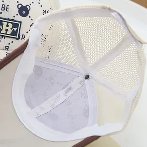 Detail view of the breathable mesh back and reinforced inner lining of the baby baseball cap