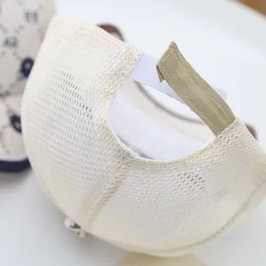 Macro view of beige toddler baseball cap mesh and adjustable velcro strap closure
