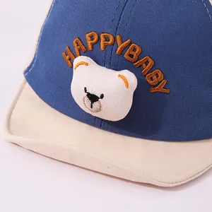 Close-up of baby baseball cap featuring 3D plush bear and HAPPYBABY embroidery detail