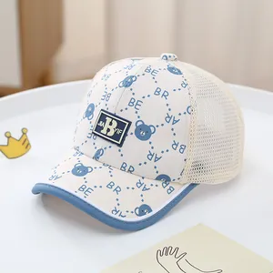 Detail of baby mesh baseball cap with blue bear print and breathable cream fabric
