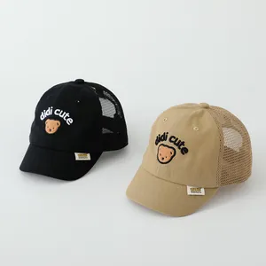 Detailed close-up of mesh summer baseball caps for kids with bear embroidery and mesh back