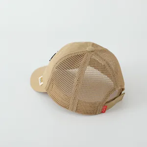 Detail of khaki toddler mesh trucker hat with breathable mesh and cute red label