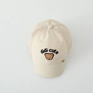 Detail of beige mesh baby baseball cap with cute bear embroidery and didi cute text