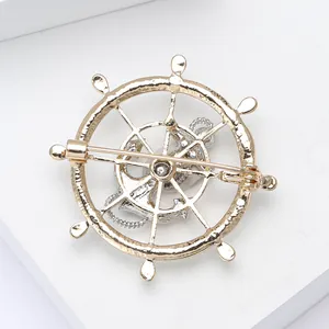 Detail view of the metal safety pin fastener on the back of the nautical brooch
