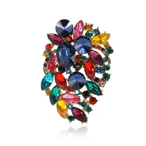 Exquisite cluster of multi-colored gemstones on gold alloy brooch with crystal accents