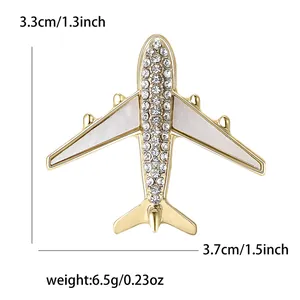 Detail showing gold airplane brooch dimensions 3.7cm by 3.3cm with weight 6.5g