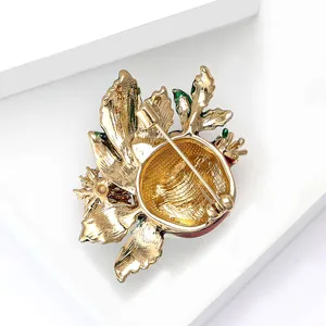 Macro shot of the safety pin buckle and gold-plated back on pomegranate enamel brooch