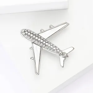 Creative silver airplane brooch with sparkling rhinestones and white enamel finish