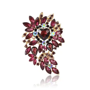 Elegant vintage red heart crystal brooch with gold alloy floral accents on white background