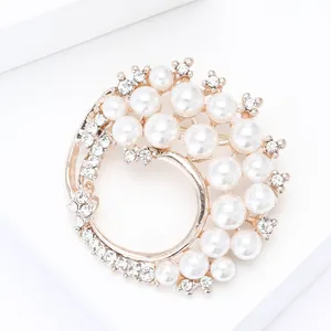 Detailed view of elegant gold pearl wreath brooch with sparkling rhinestones for suits