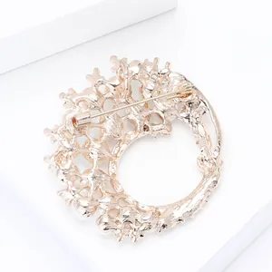 Detail of elegant rose gold floral brooch showing the secure pin closure and back structure