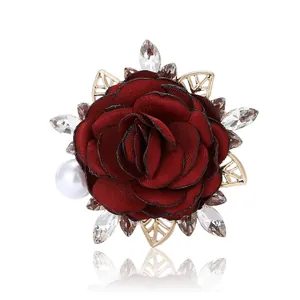 Elegant deep red satin rose brooch with white pearl and sparkling rhinestones on gold leaves