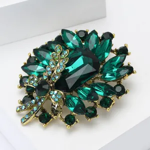 Vintage emerald crystal floral brooch with green gemstones and gold alloy setting