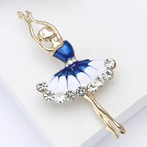 Detail of elegant gold ballerina brooch with blue enamel dress and sparkling crystals