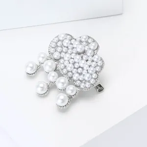 Detailed view of silver alloy cloud brooch with cluster pearls and hanging pendants