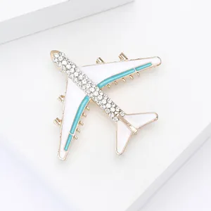 Detailed macro of airplane brooch with sparkling crystals and colorful enamel accents