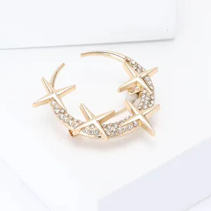 Elegant gold celestial brooch featuring sparkling moon and stars inlaid with white rhinestones