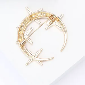 Macro view of the gold moon and star brooch pin back with secure metal clasp detail