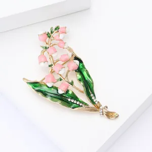 Elegant lily of the valley enamel brooch with green leaves and gold-plated details