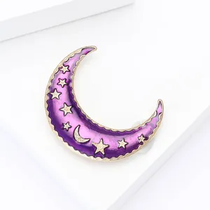 Detailed close-up of a purple enamel crescent moon brooch with celestial gold star patterns